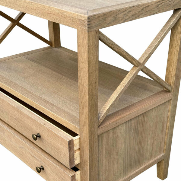 Close-up of a Hamptons Natural Reclaimed Double Drawer Medium Wood Bedside Table featuring an open drawer and crossbeam supports, with a textured finish and metal handles.