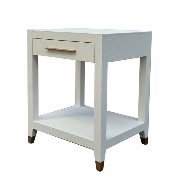 A small, Modern Simple Contemporary Style Grass Cloth Gold Handle Reef Side Table Bedroom Furniture Bedside Table with a single drawer and a lower shelf, set on short dark oak legs, isolated on a white background.