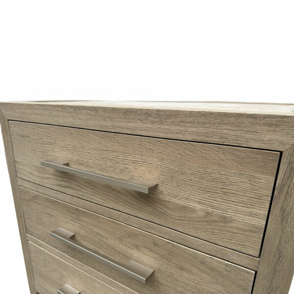 Close-up of a Luxury Contemporary Bedroom Furniture extended chest of drawers showing detail of the grain and metal handles, with a white background.