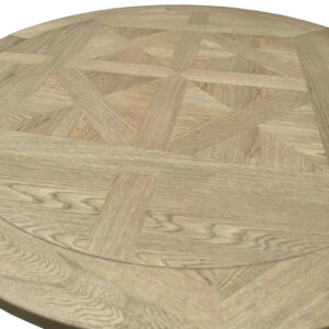 A close-up of the Antique Solid Oak Round Kitchen Table reveals an intricate geometric pattern on its surface.