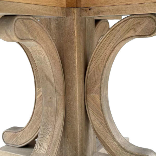 The Solid Oak Round Kitchen Table features intricately carved legs and a natural oak finish, adding timeless elegance to its Mid-Century Modern style.