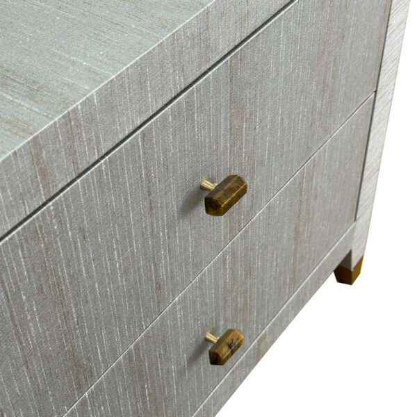 Close-up of a luxury gray nightstand with two drawers, brass handles & feet, showcasing modern elegance.