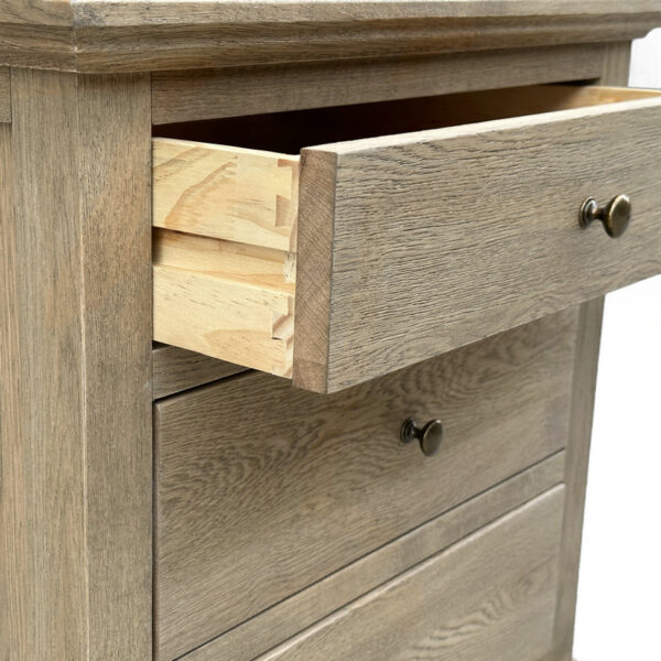 A partially open drawer in a French Rustic 3-Drawer Wood Nightstand with metal knobs.