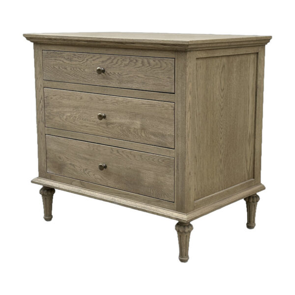 The Rustic Oak 3-Drawer Nightstand boasts round metal knobs and short turned legs, perfect for adding elegance to your bedroom.