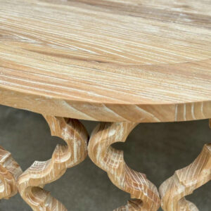 Here's a close-up of the French Vintage Handcrafted Recycled Elm Round Coffee Table, with an ornate base and light natural finish.