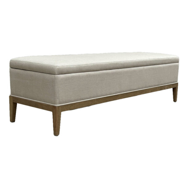 Natural linen rectangular ottoman with wooden legs and cushioned top, perfect for changing shoes or as a footrest.