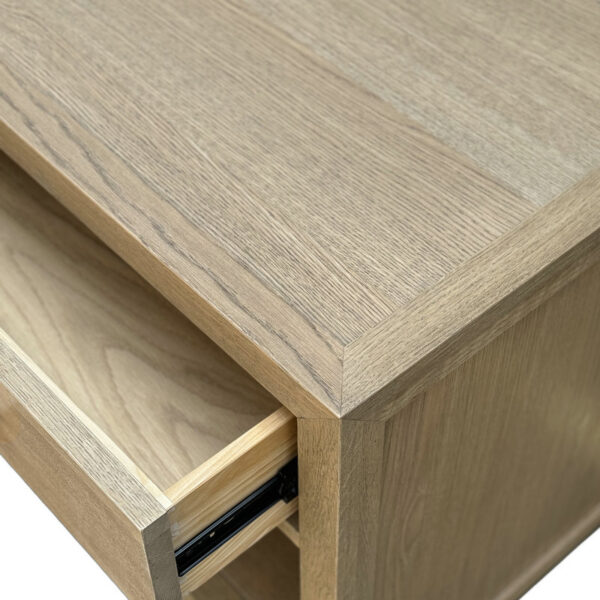 Close-up of a partially open drawer on the French Natural Oak Night Table, showing metal runners. The wood has a light, smooth finish.