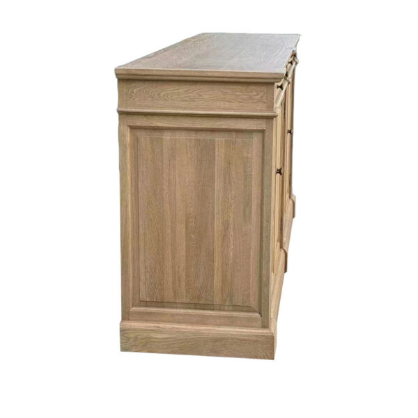 Side view of the handcrafted solid oak cupboard, featuring simple paneling and a flat top in an antique French style.