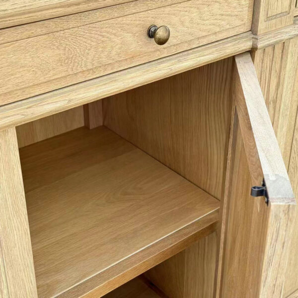 Open the Antique French Style Handcrafted Solid Oak Cupboard with a drawer and door, revealing an empty shelf. Features brass knob and light oak wood.