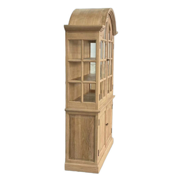 Side view of French-style solid oak hutch with curved top, glass doors, shelves, and solid wooden doors on the bottom.