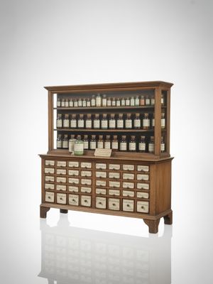 Vintage Apothecary Pharmacy Cabinet with multiple small drawers, wooden display shelf for medicines, herbs, or spices, functional storage furniture, classic interior decor piece.