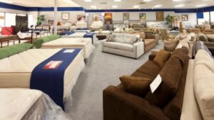 Comfortable sofas and mattresses displayed in furniture showroom for sale, featuring various styles and fabrics to suit any home decor, emphasizing quality sleep and cozy living.