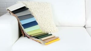 Color swatches on a modern white sofa, showcasing a variety of fabric and upholstery options for interior design and home decor. Perfect for selecting stylish, high-quality materials for furniture upholstery.