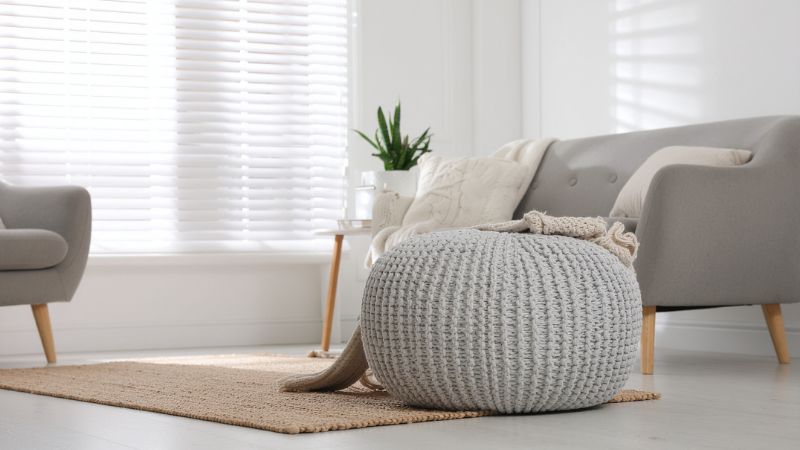 Soft, stylish living room with modern furniture and plush cushions, featuring natural light and minimalistic design, ideal for creating a warm and inviting home environment.