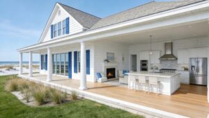 Bright Hamptons-style beach house with white exterior, large windows, and spacious outdoor living area. Perfect for creating casual luxury and relaxing by the ocean.