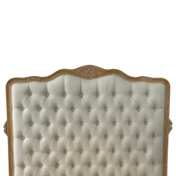 Elegant vintage upholstered bed frame with tufted fabric and intricate wood carvings, perfect for a luxurious bedroom setting. Crafted from solid wood, combining timeless style with durability.