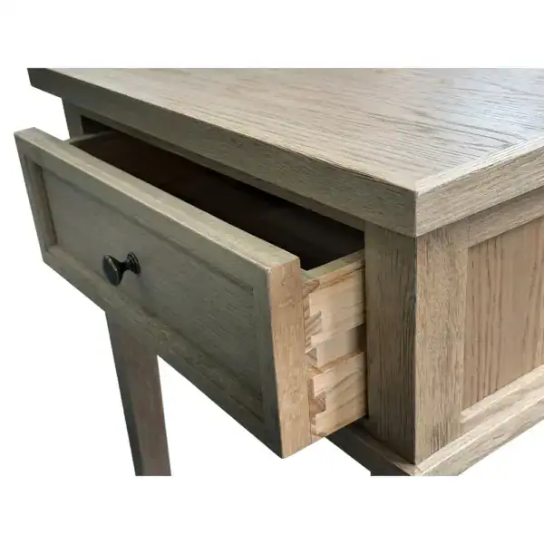 Antique wooden side table featuring a single drawer with a round knob, perfect for small spaces. Crafted from light-colored wood, this vintage-style table adds charm and functionality to any room.