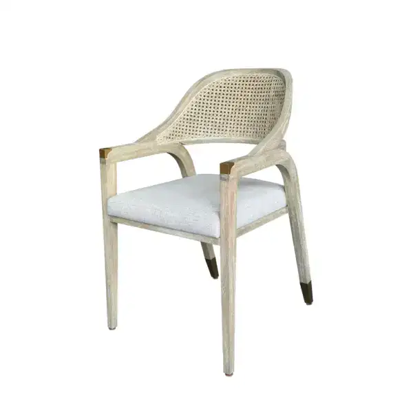 Elegant vintage French rattan dining armchair featuring a woven rattan backrest and a comfortable linen cushion seat, perfect for classic or rustic dining spaces.