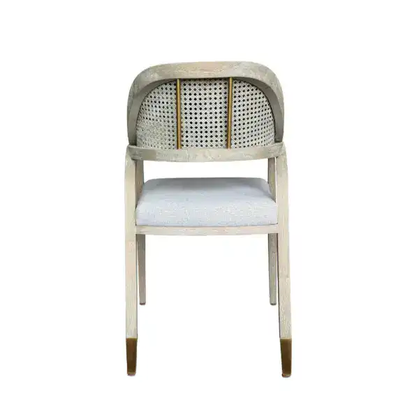 French rattan dining armchair with vintage design and linen upholstered seat cushion, perfect for elegant dining spaces and classic interior decor.