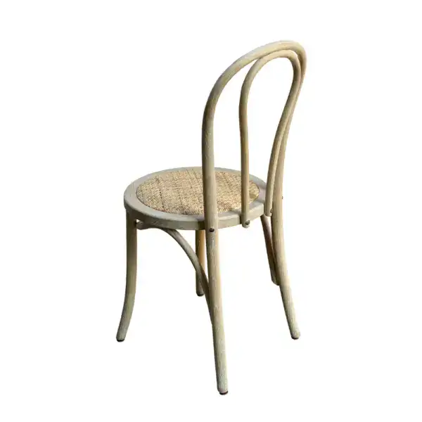 Elegant vintage French-style rattan and bentwood dining chair with curved backrest and woven seat, perfect for classic or rustic interior decor.