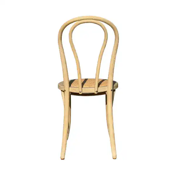 Vintage French style rattan and bentwood dining chair with a curved backrest and natural wood finish, perfect for classic and rustic interior decor.