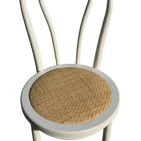 Elegant vintage French-style dining chair with a bentwood frame and woven rattan seat, perfect for classic and rustic interior decor.